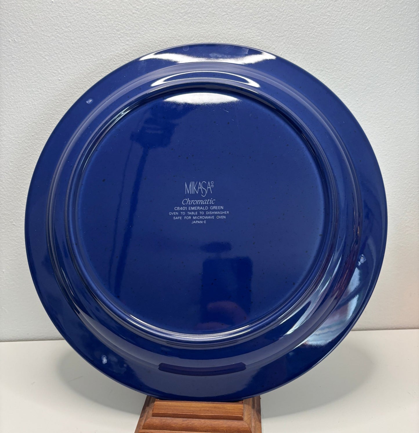 Blue ceramic plate with 'Mikasa' branding on a white background