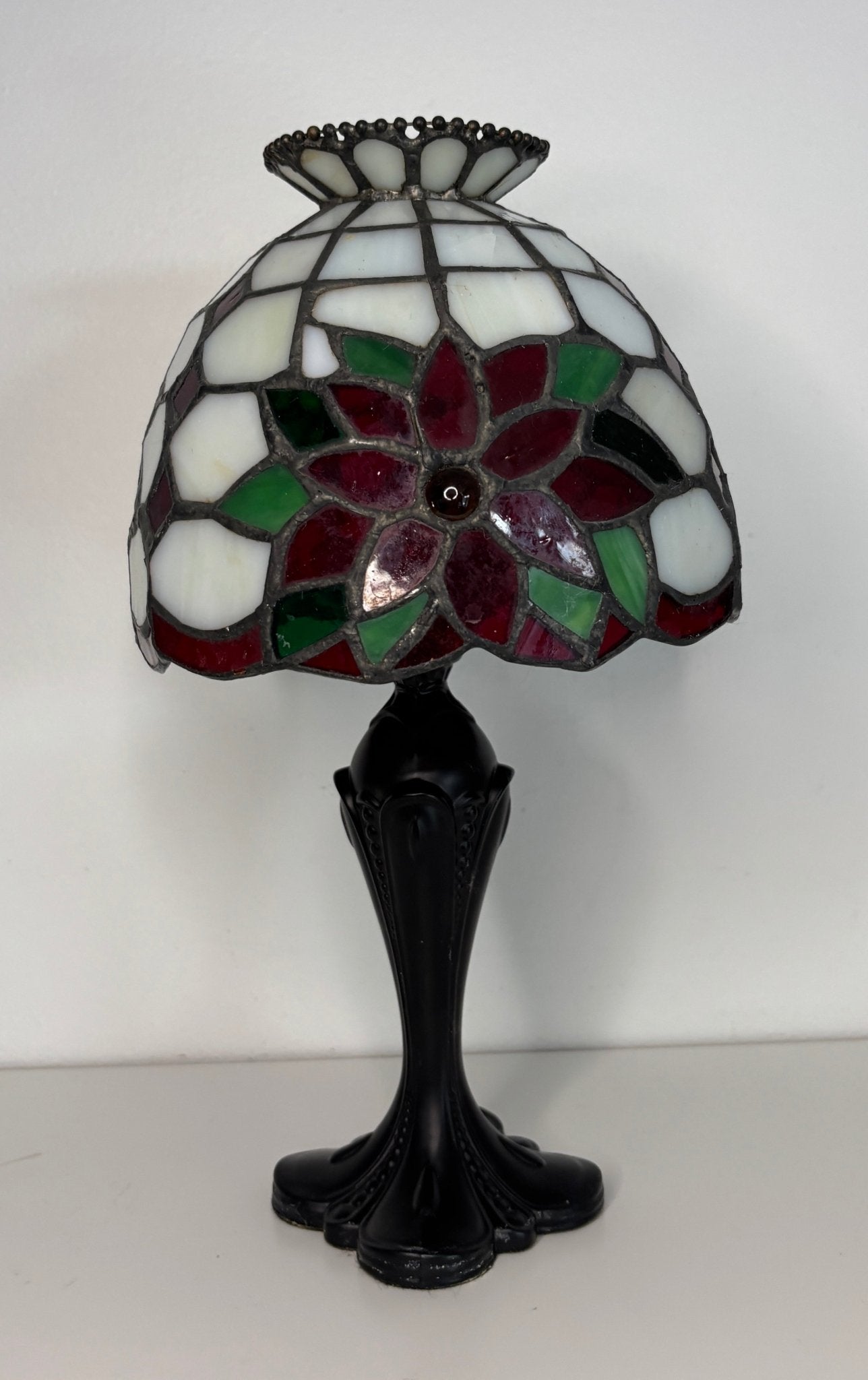 Tiffany-style lamp with stained glass shade on a white background