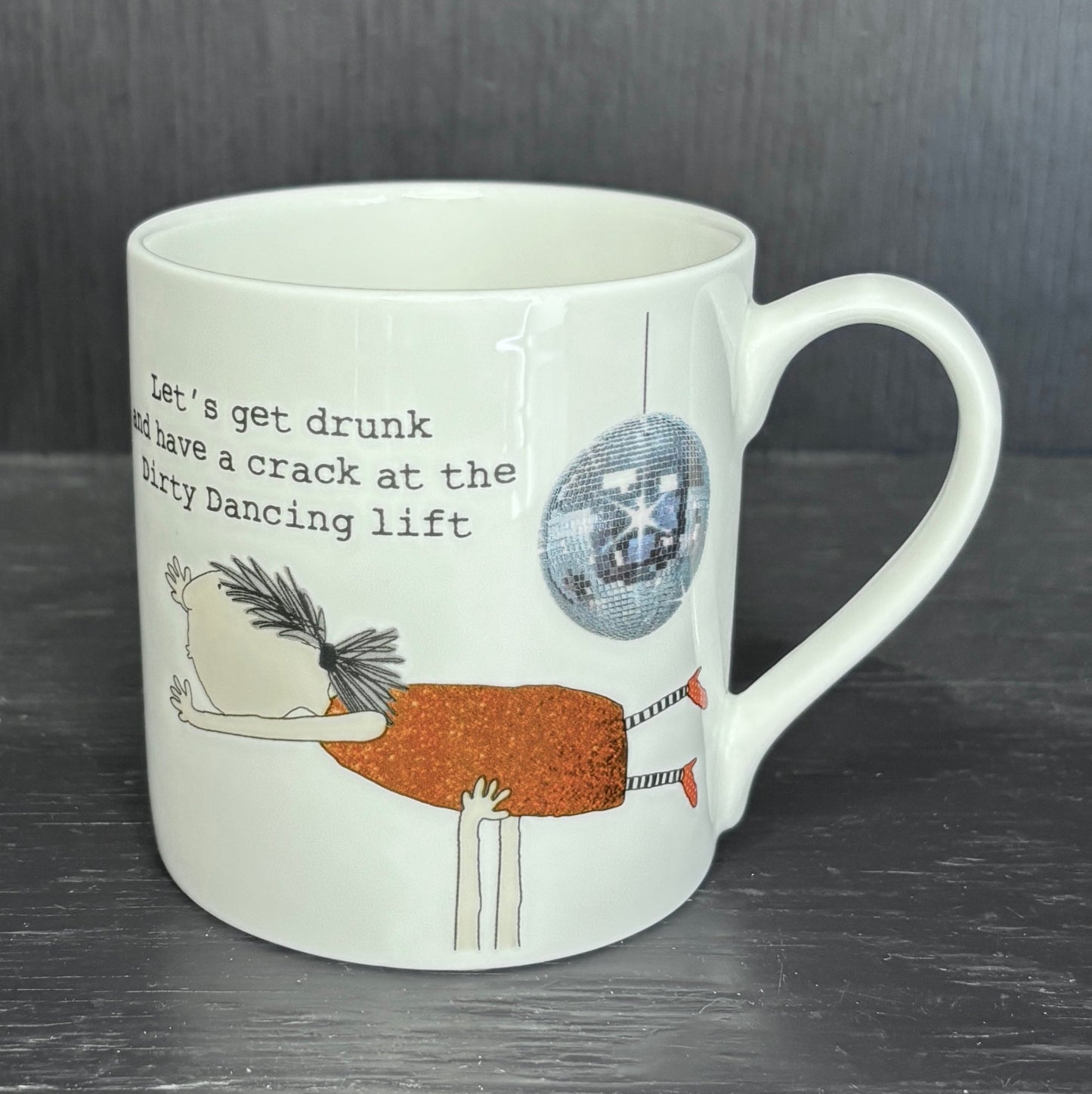 Mug with humorous design and text on a dark surface