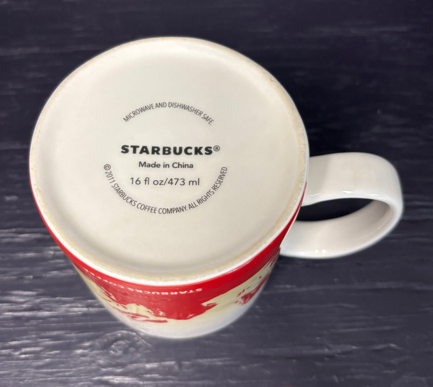 red and white Starbucks China Coffee Mug with designs of scorpions and mountains