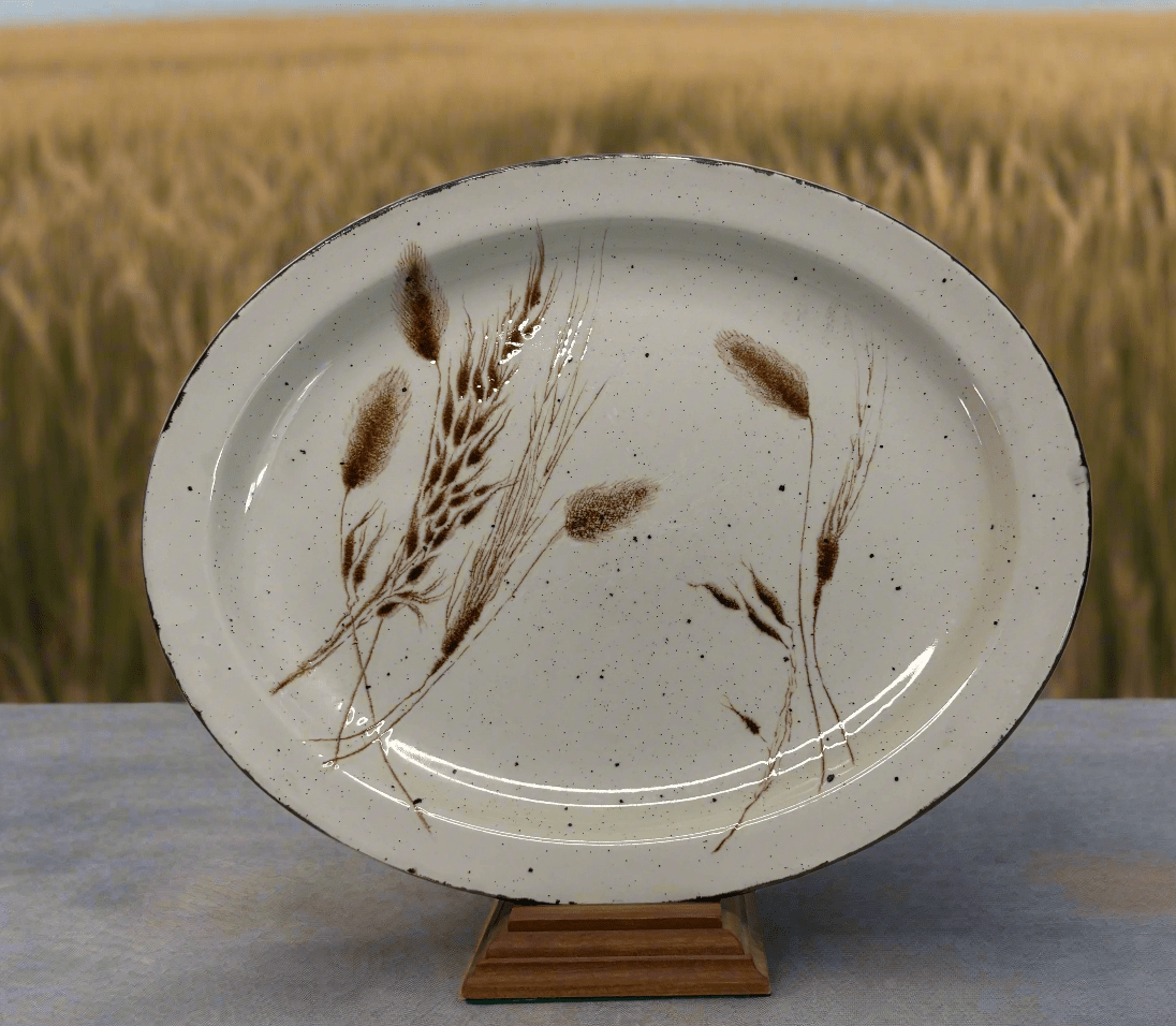 Ceramic plate with brown floral design on a stand against a blurred field background
