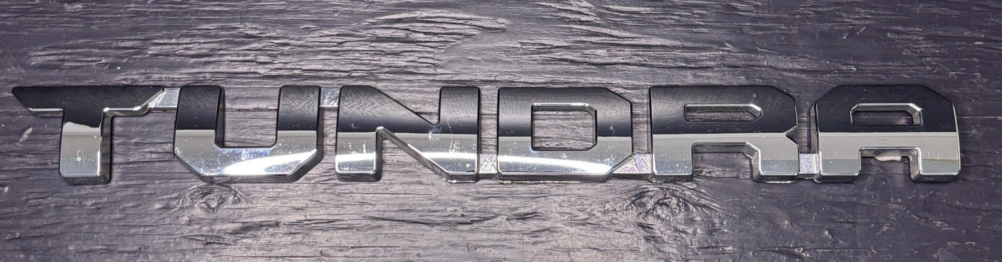 Metallic 'TUNDRA' logo on a textured surface
