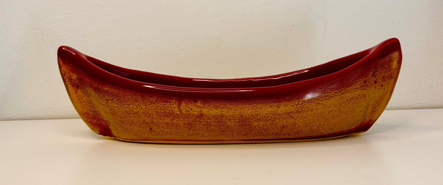 Ceramic canoe-shaped bowl on a white background