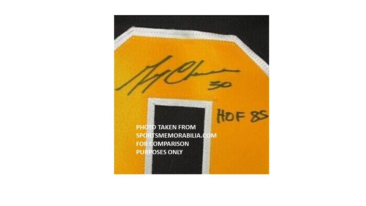 Yellow sports jersey with a signature and 'HOF 85' text on a white background