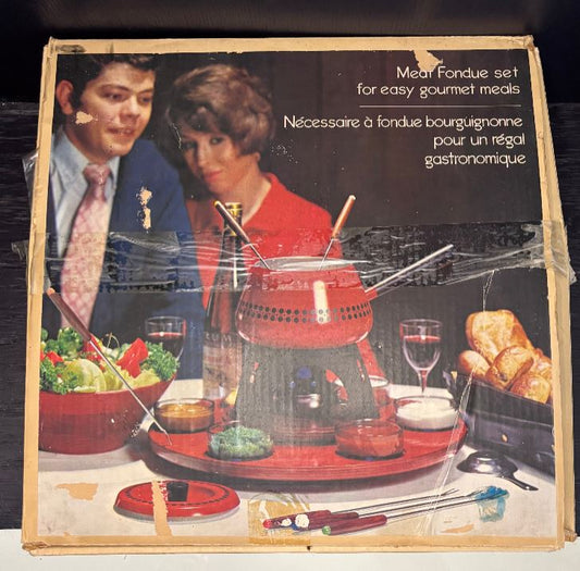 Vintage Meat Fondue set packaging with a couple and fondue setup illustration.