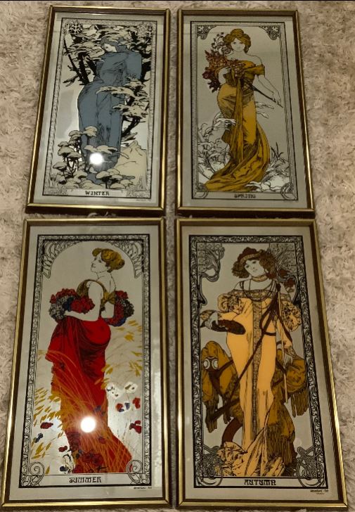 Four framed illustrations of women in different seasons on a textured wall.