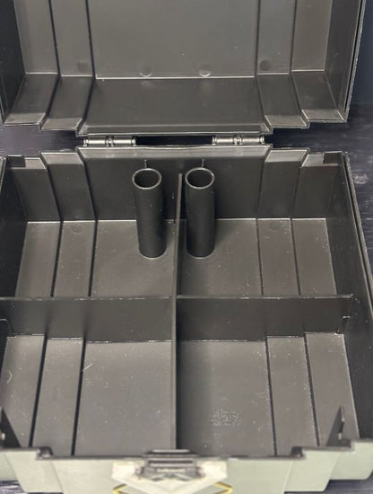 Black metal tool box with open lid showing two cylindrical components inside.