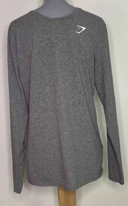 Gray long-sleeve shirt with a logo on a mannequin against a white background