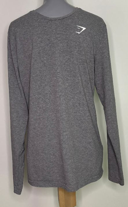 Gray long-sleeve shirt with a logo on a mannequin against a white background