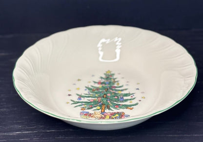 Decorative ceramic bowl with a Christmas tree design on a dark background