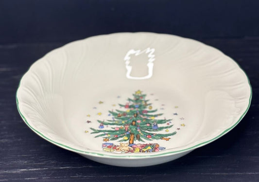 Decorative ceramic bowl with a Christmas tree design on a dark background