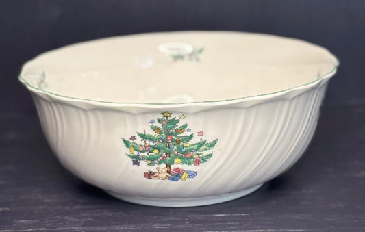White ceramic bowl with Christmas tree design on a dark background
