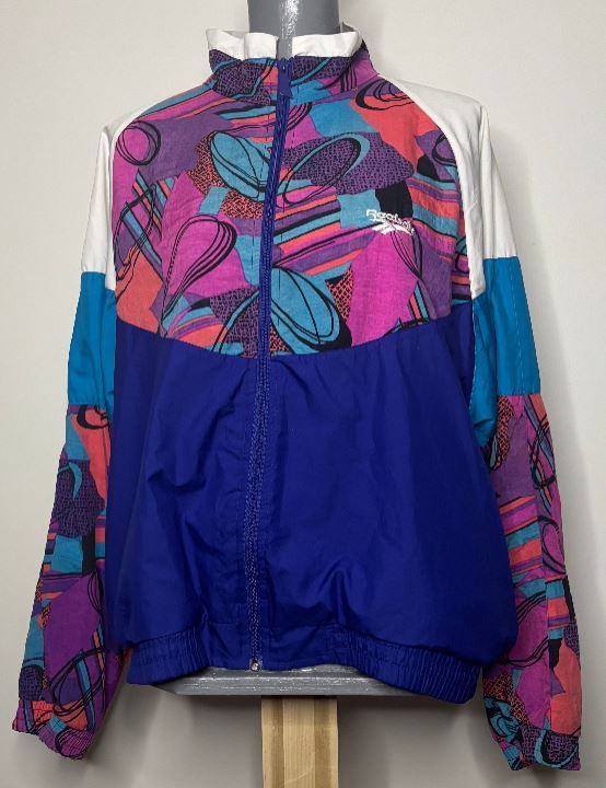 Colorful jacket with abstract patterns on a mannequin against a white background