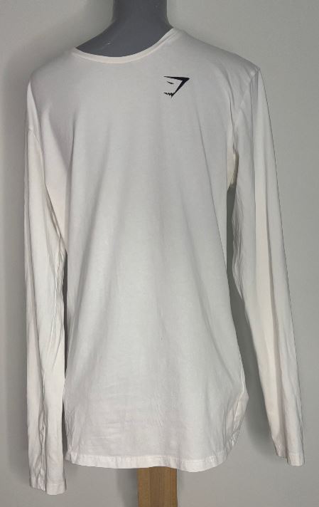 White long-sleeve shirt with a black logo on a mannequin against a gray background