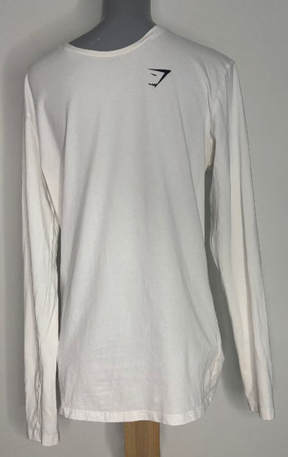 White long-sleeve shirt with a black logo on a mannequin against a gray background