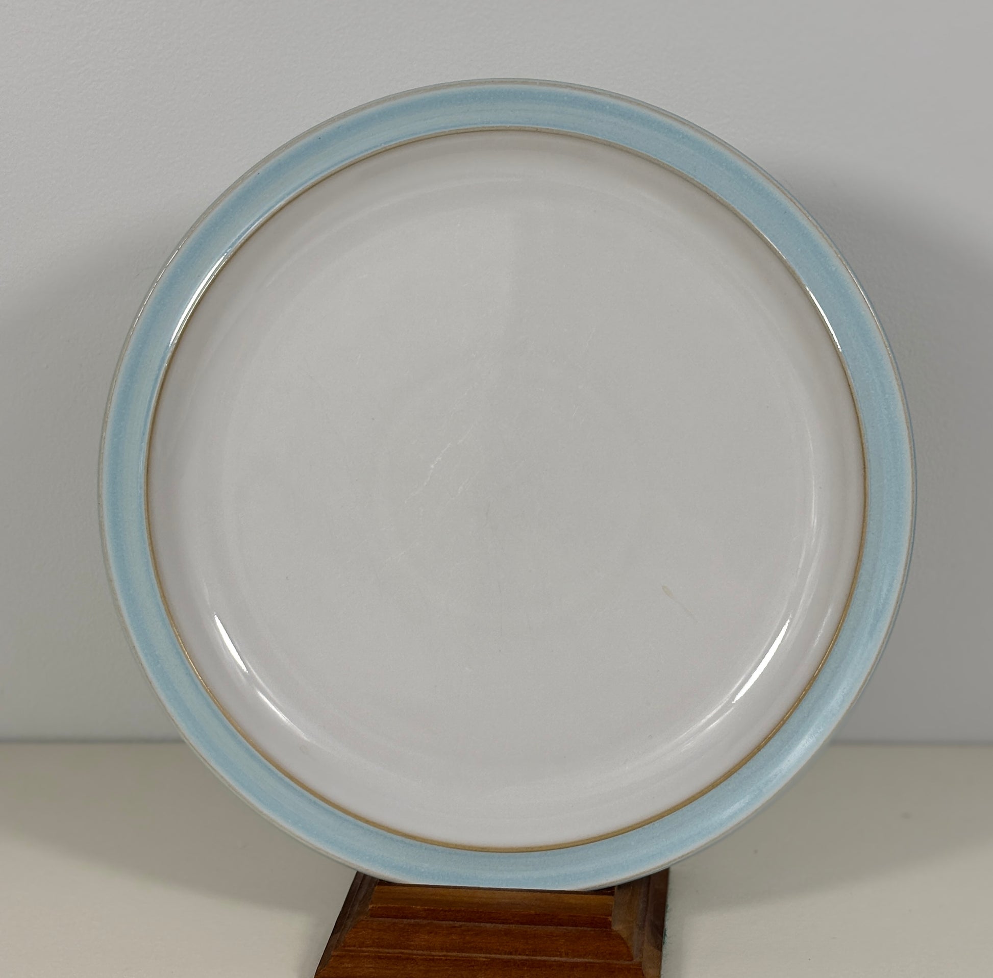 White plate with a blue rim on a white background