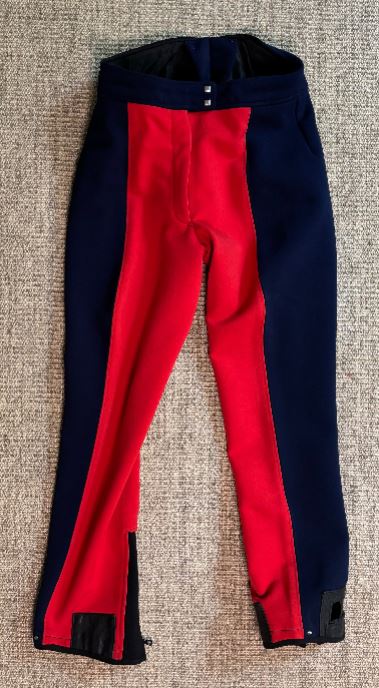 Red and navy blue pants on a textured surface