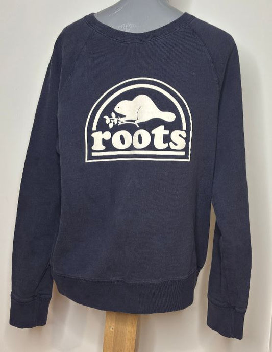 Navy blue sweatshirt with 'roots' logo on a mannequin against a white background
