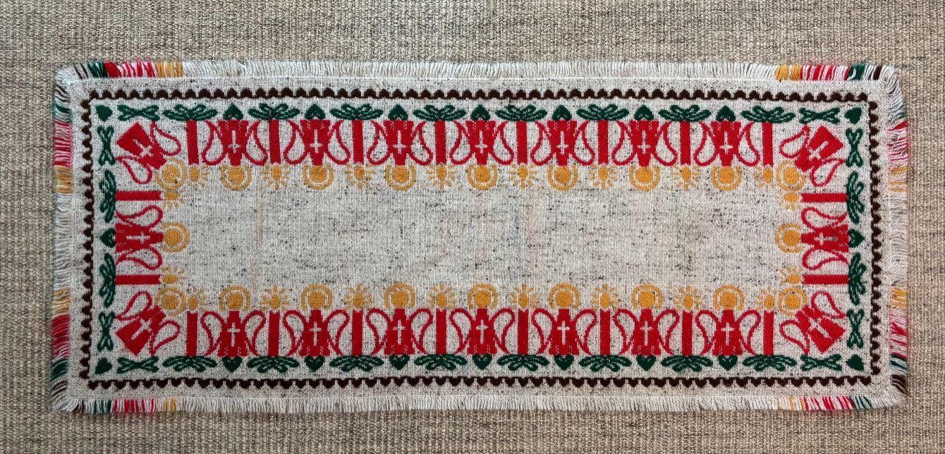 Decorative woven mat with intricate patterns on a textured surface
