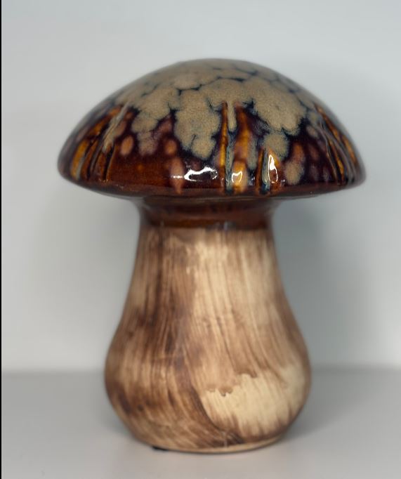 Ceramic mushroom with brown and beige glaze on a white background