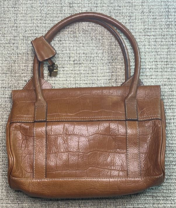 Brown leather handbag on a textured surface