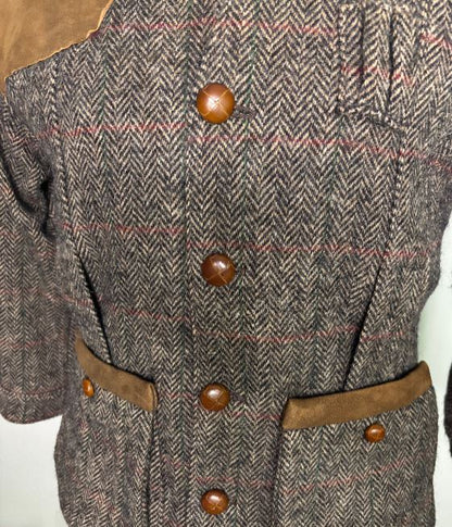 Close-up of a textured fabric with brown buttons on a neutral background