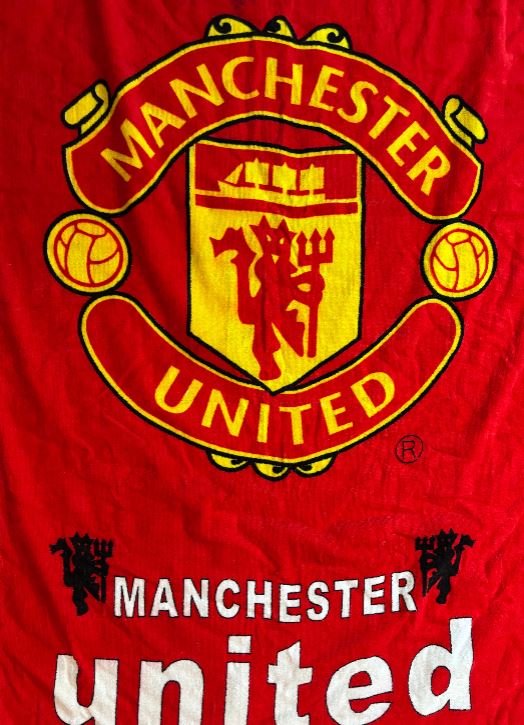 Manchester United logo on a red background