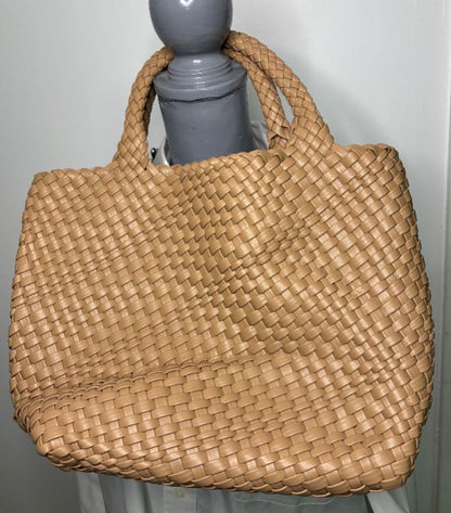 Woven brown handbag on a gray surface