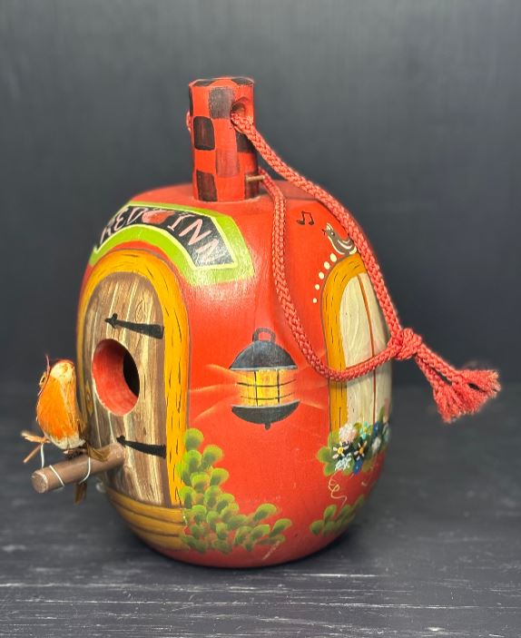 Decorative gourd with colorful designs on a dark background