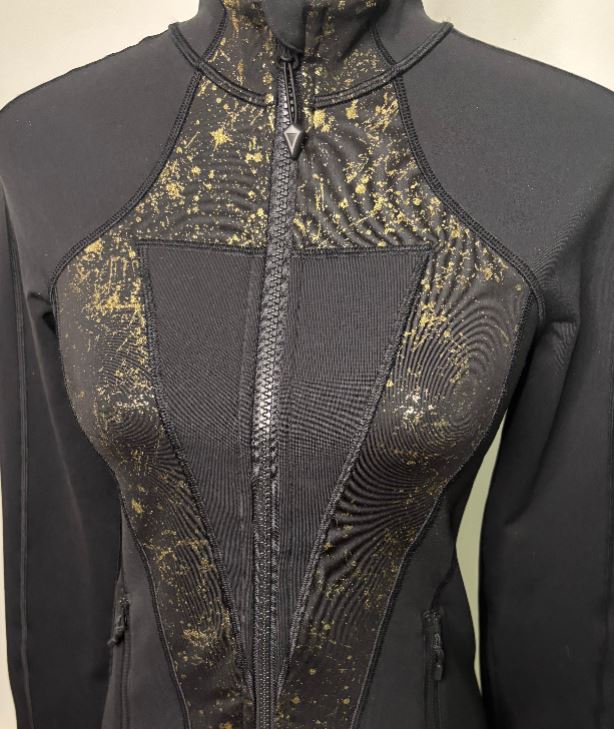 Black and gold patterned jacket on a mannequin against a neutral background