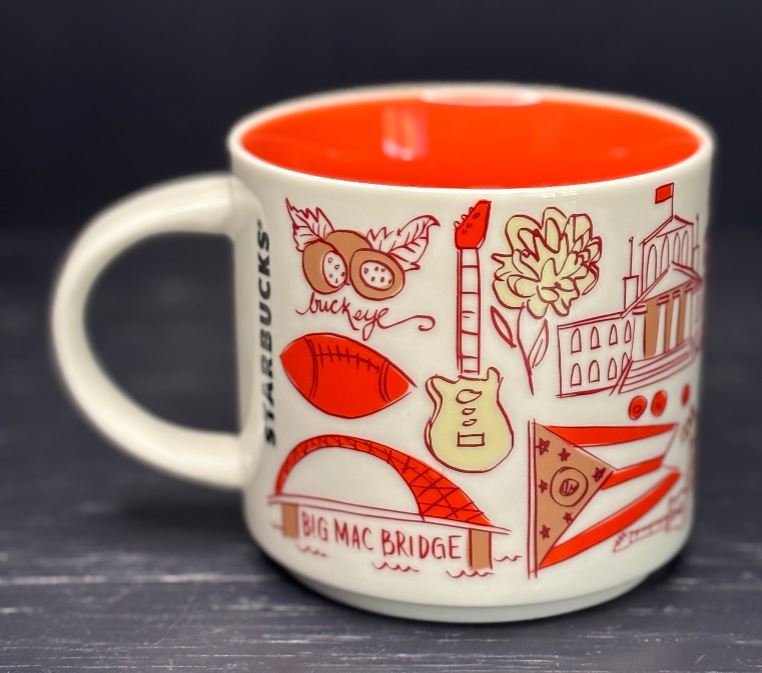 Starbucks mug with red interior and various illustrations on a dark background