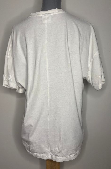 White t-shirt on a mannequin against a gray background