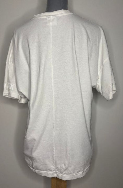 White t-shirt on a mannequin against a gray background