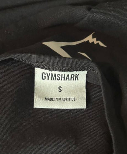 Gymshark label on a black garment with a logo.