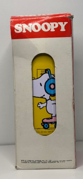 Snoopy skateboard deck in packaging with red 'Snoopy' label