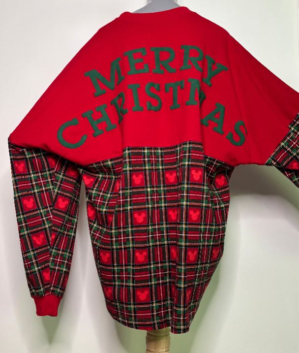 Red sweater with plaid pattern and 'Merry Christmas' text on a white background