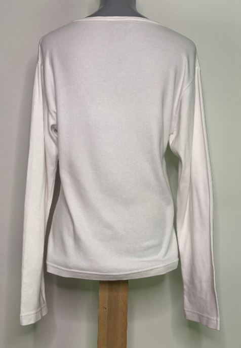 White long-sleeve shirt on a mannequin against a plain background