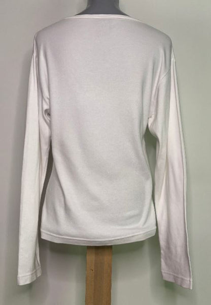 White long-sleeve shirt on a mannequin against a plain background