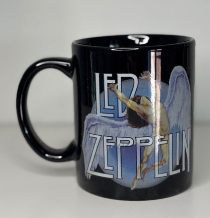 Black mug with Led Zeppelin logo and angelic design on a gray background