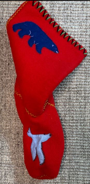 Red golf club head cover with blue and white bear designs on a textured surface