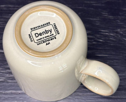 Denby mug with a label on a dark background