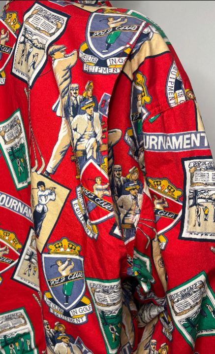 Red shirt with vintage-style graphics and text on a gray background