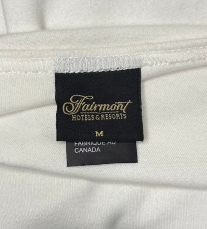 Close-up of a Fairmont Hotels & Resorts label on white fabric.