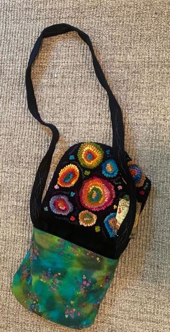 Colorful handbag with bead embellishments on a textured surface