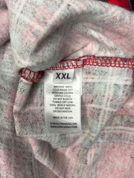 Close-up of a label on a piece of clothing with text and a brand logo.