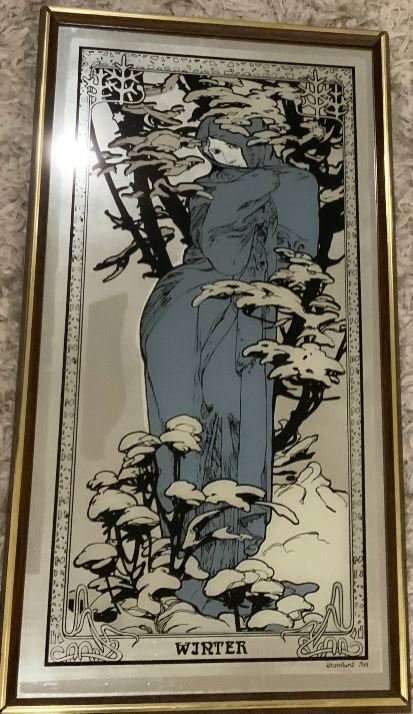 Framed artwork of a stylized figure in a blue dress among trees and plants.