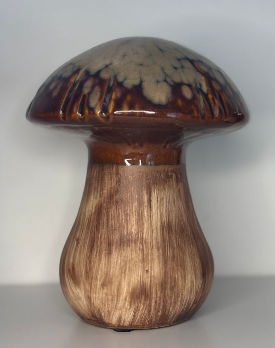 Ceramic mushroom sculpture on a plain background