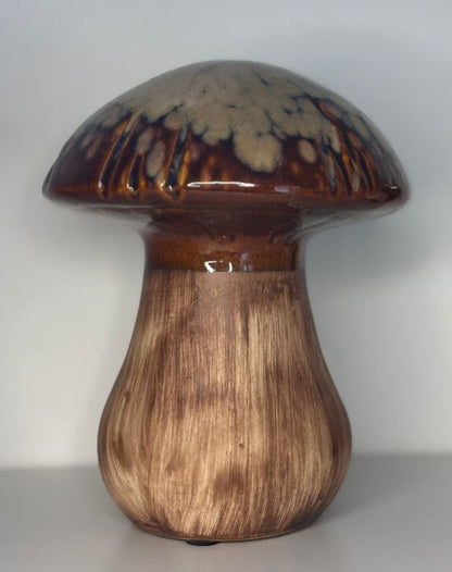 Ceramic mushroom sculpture on a plain background