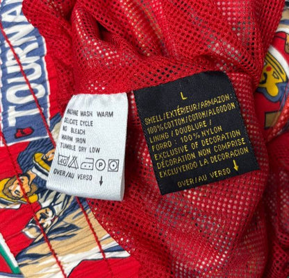 Clothing label on a colorful garment with text and symbols.