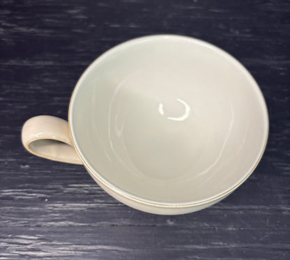White ceramic mug on a dark wooden surface